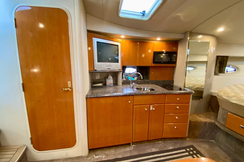Slide: The Image of 2004 Formula 37 PC yacht interior with kitchenette, TV, and cozy sleeping area. - 24