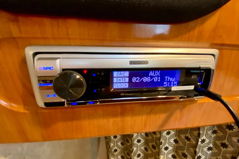 Slide: The Image of Kenwood stereo system in 2004 Formula 37 PC boat, displaying AUX mode and time. - 31