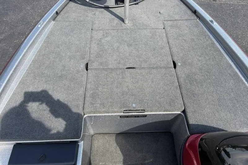 Slide: The Image of 2008 Skeeter ZX190 boat deck with gray carpet and storage compartments. - 11