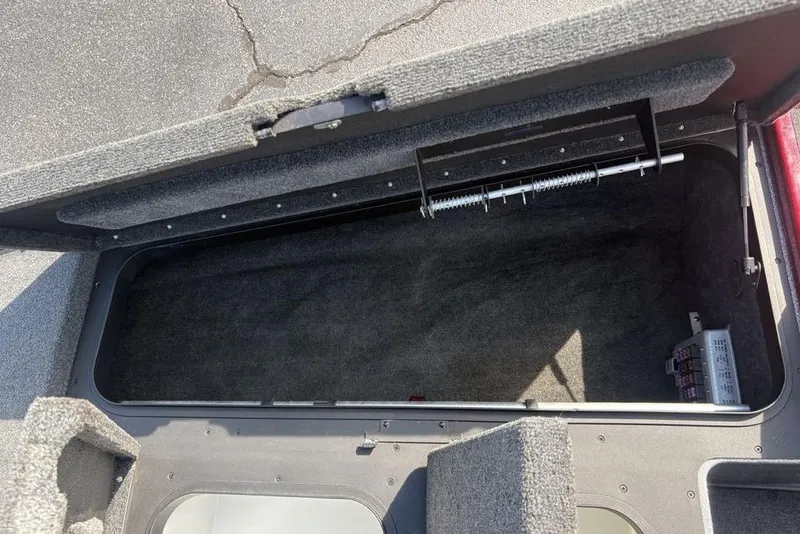 Slide: The Image of Open storage compartment in a 2008 Skeeter ZX190 boat, showing interior details. - 12