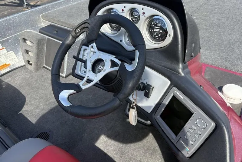Slide: The Image of 2008 Skeeter ZX190 boat dashboard with steering wheel and electronic display. - 14