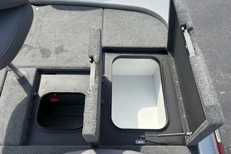 Slide: The Image of 2008 Skeeter ZX190 boat storage compartments with open lids, showcasing interior space. - 24