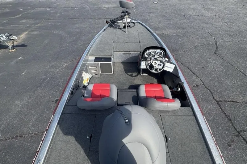 Slide: The Image of 2008 Skeeter ZX190 boat interior with red and gray seating, steering console, and spacious deck. - 29