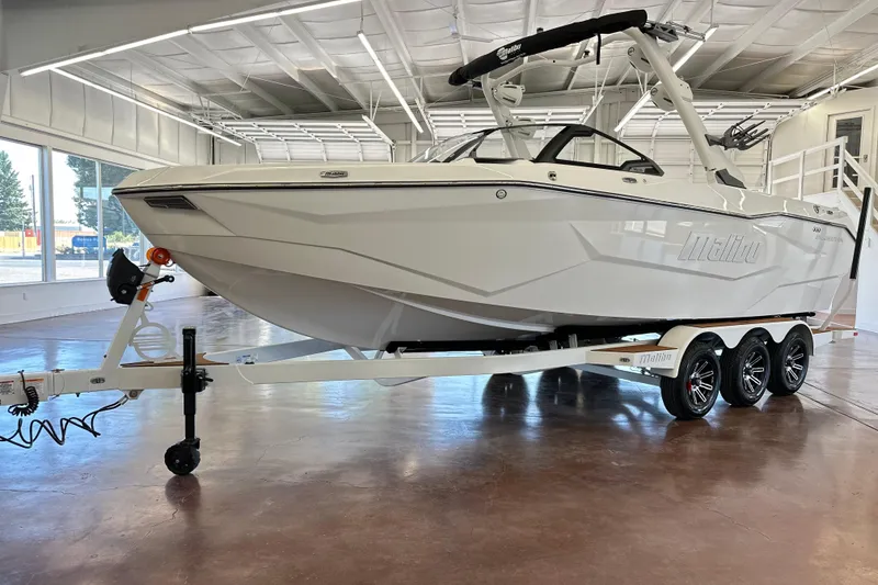 The Image of 2026 Malibu Wakesetter 25 LSV boat on trailer in showroom. - 1