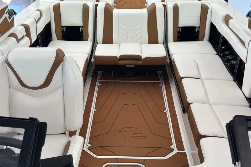 Slide: The Image of 2026 Malibu Wakesetter 25 LSV interior with luxurious white and brown seating. - 10