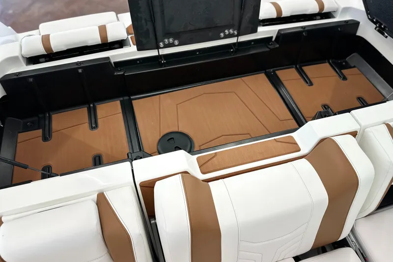Slide: The Image of 2026 Malibu Wakesetter 25 LSV interior with white and brown seating and storage compartments. - 13