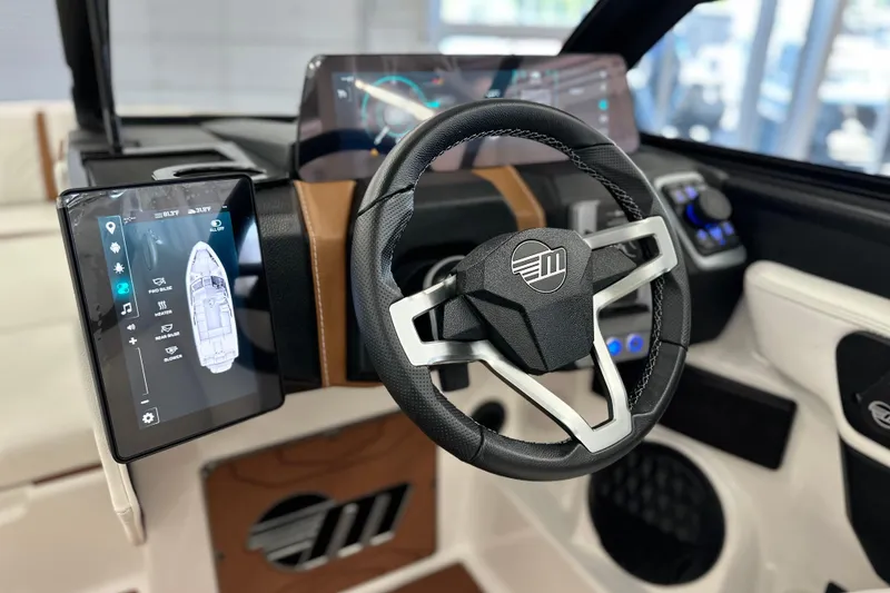 Slide: The Image of 2026 Malibu Wakesetter 25 LSV dashboard with advanced touchscreen controls and steering wheel. - 18