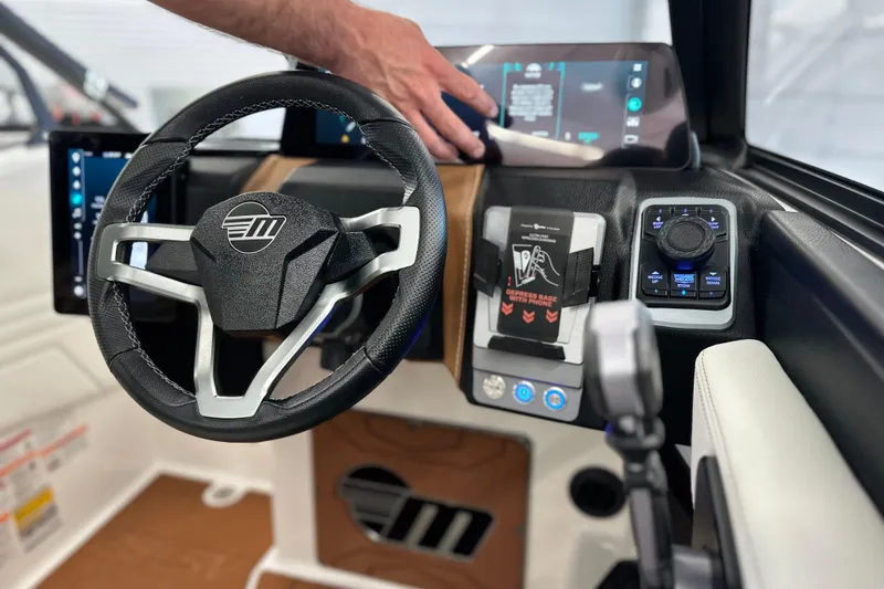 Slide: The Image of 2026 Malibu Wakesetter 25 LSV dashboard with steering wheel and control panel. - 19