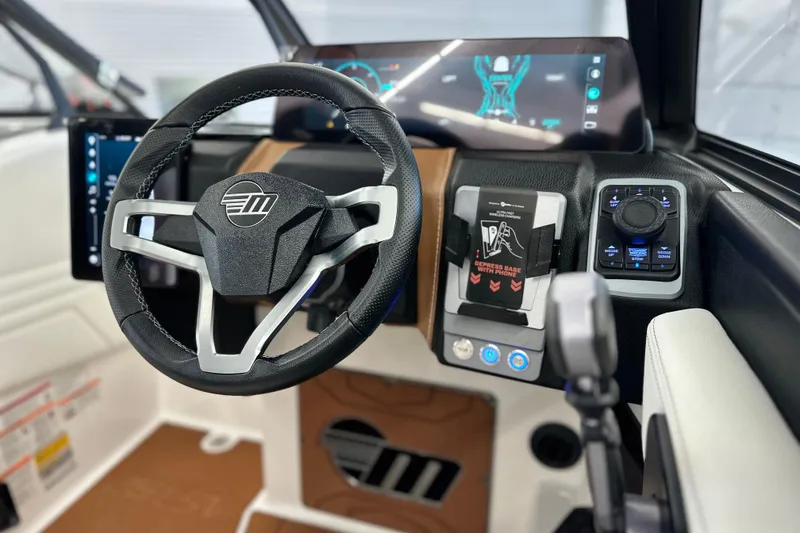 Slide: The Image of 2026 Malibu Wakesetter 25 LSV dashboard with modern steering wheel and digital controls. - 20