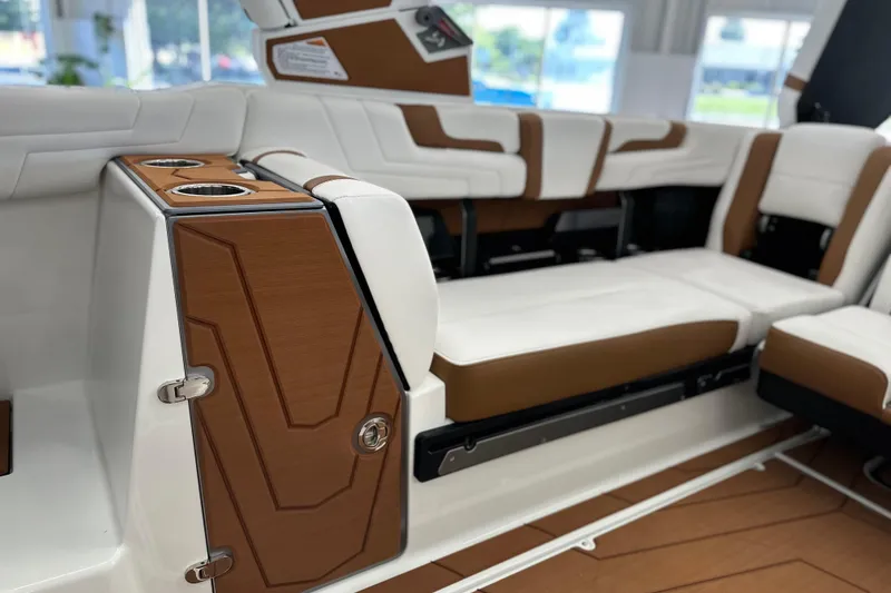 Slide: The Image of 2026 Malibu Wakesetter 25 LSV interior with white and brown seating, cup holders, and sleek design. - 22