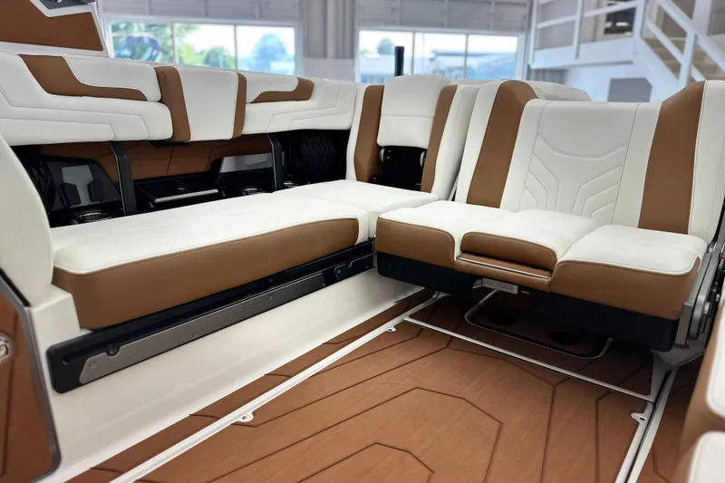 Slide: The Image of 2026 Malibu Wakesetter 25 LSV interior with luxurious white and brown seating. - 23