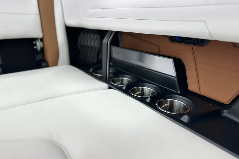 Slide: The Image of Interior of 2026 Malibu Wakesetter 25 LSV with cup holders and white seating. - 25