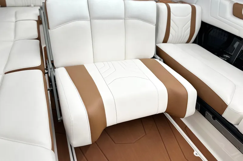 Slide: The Image of Luxurious interior seating of 2026 Malibu Wakesetter 25 LSV boat, featuring white and brown upholstery. - 27