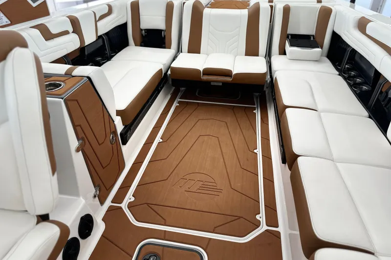 Slide: The Image of Luxurious interior of 2026 Malibu Wakesetter 25 LSV boat with white and brown seating. - 29