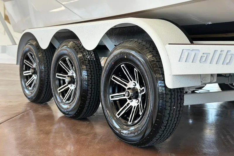 Slide: The Image of 2026 Malibu Wakesetter 25 LSV trailer with sleek black alloy wheels. - 6