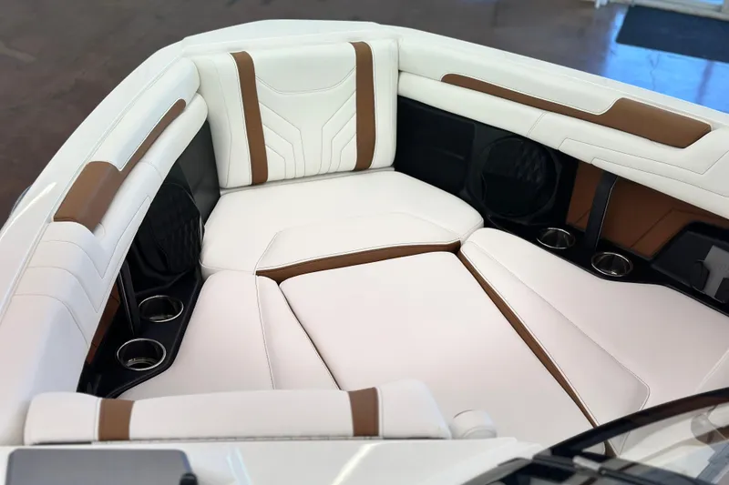 Slide: The Image of 2026 Malibu Wakesetter 25 LSV interior with white and brown seating, cup holders. - 9