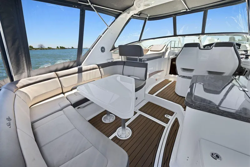 Slide: The Image of Interior of 2014 Sea Ray 350 Sundancer yacht with elegant seating and table. - 14