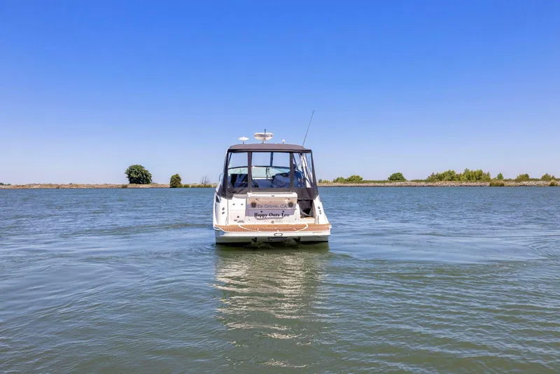 Slide: The Image of 2014 Sea Ray 350 Sundancer cruising on a calm lake under clear blue skies. - 3
