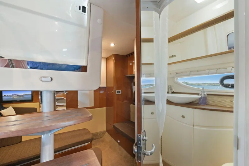 Slide: The Image of Interior of 2014 Sea Ray 350 Sundancer yacht, featuring modern design and wooden finishes. - 31