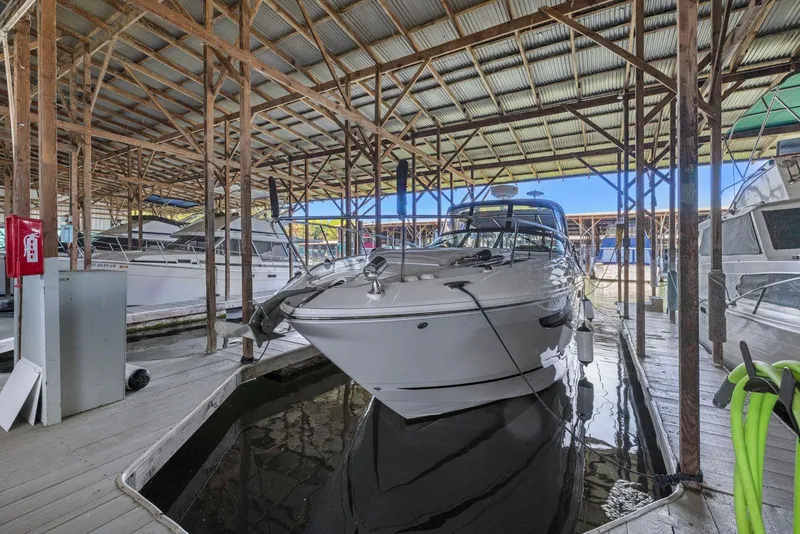Slide: The Image of 2014 Sea Ray 350 Sundancer docked in a covered marina. - 34