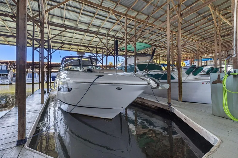 Slide: The Image of 2014 Sea Ray 350 Sundancer docked in a covered marina. - 36