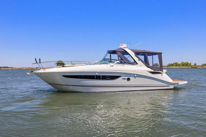 Slide: The Image of 2014 Sea Ray 350 Sundancer yacht on calm water under clear blue sky. - 5