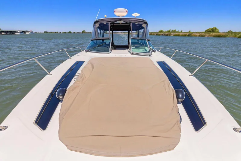 Slide: The Image of 2014 Sea Ray 350 Sundancer boat on water, featuring a spacious deck and sleek design. - 6