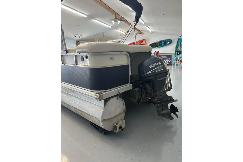 Slide: The Image of 2005 Bennington 2250RFS pontoon boat with Yamaha outboard motor in a showroom. - 1