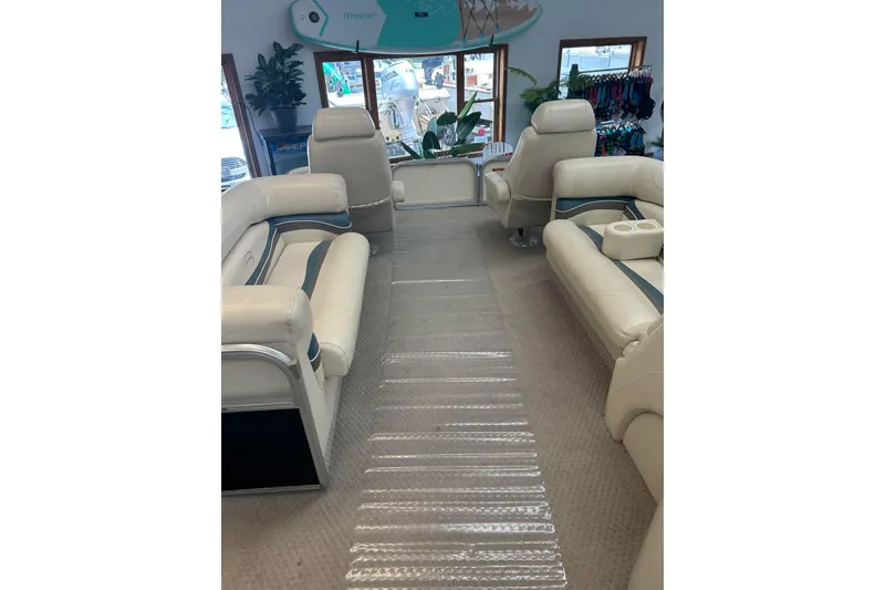 Slide: The Image of Interior of a 2005 Bennington 2250RFS boat with beige seating and clear floor mat. - 3