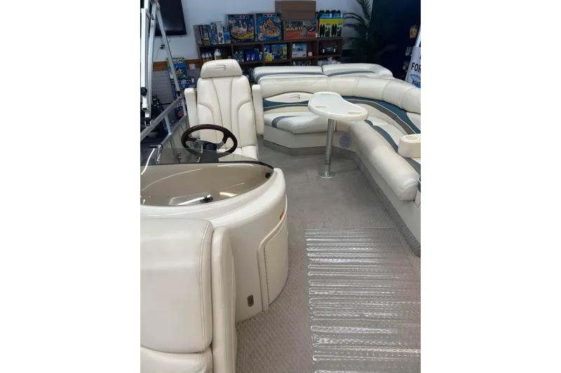 Slide: The Image of Interior of a 2005 Bennington 2250RFS boat with plush seating and steering wheel. - 4