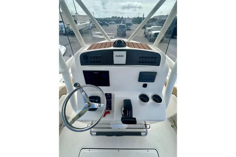 Slide: The Image of 2021 Pioneer 222 Islander boat dashboard with steering wheel and controls. - 11