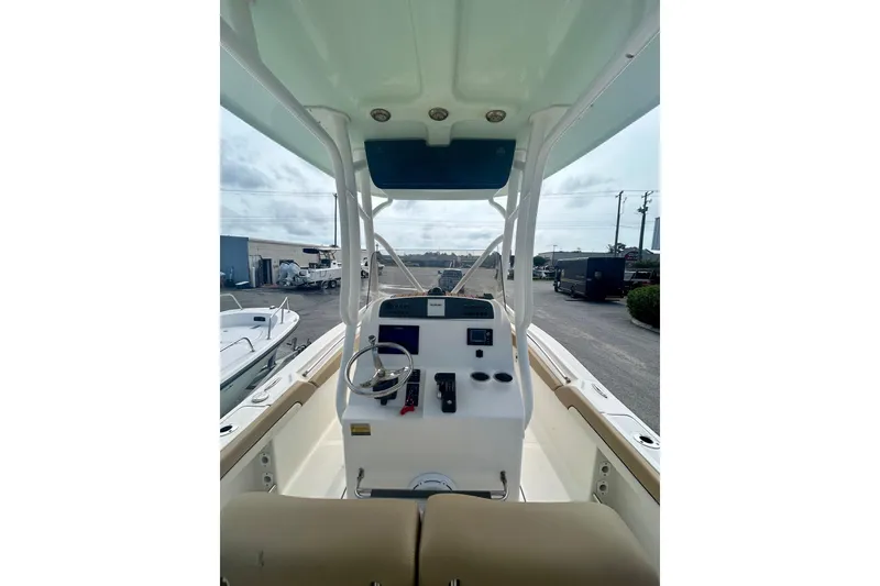 Slide: The Image of 2021 Pioneer 222 Islander boat interior with steering console and seating. - 12