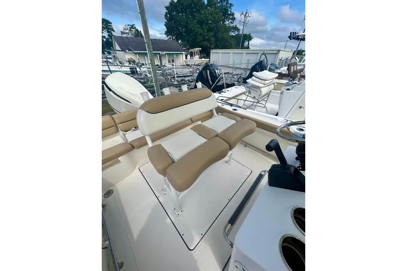 Slide: The Image of 2021 Pioneer 222 Islander boat interior with tan seating and steering console. - 13