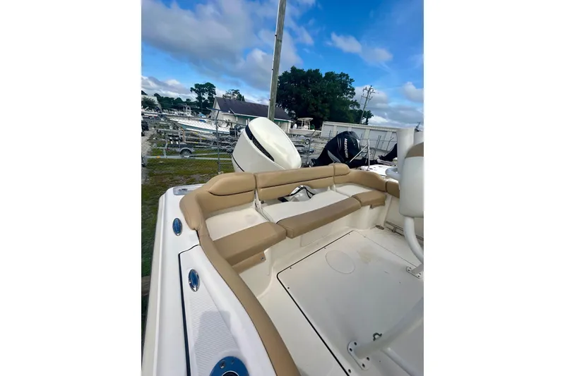 Slide: The Image of 2021 Pioneer 222 Islander boat interior with tan seating and outboard motor. - 14