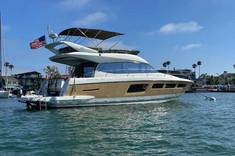 The Image of Luxury 2015 Prestige 500FB yacht docked in a sunny marina setting. - 0