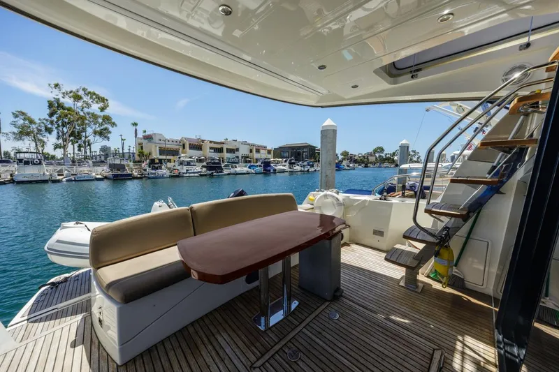 Slide: The Image of Luxury yacht deck with seating and table, Prestige 500FB, 2015 model, docked at marina. - 10