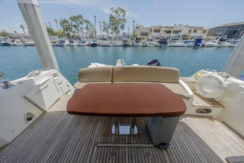 Slide: The Image of Prestige 500FB 2015 yacht deck with table, overlooking marina and boats. - 14