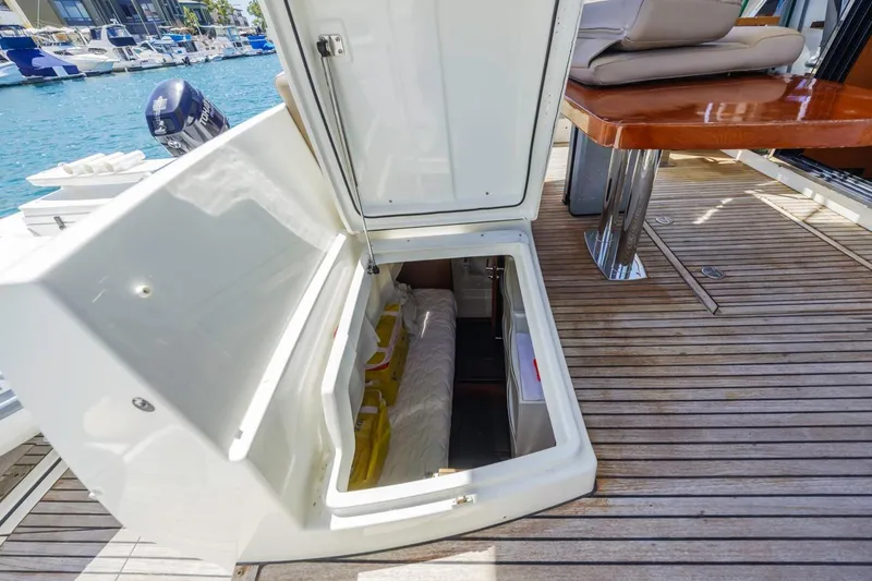 Slide: The Image of Open storage compartment on 2015 Prestige 500FB yacht deck, with marina view. - 15