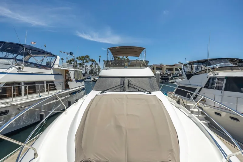 Slide: The Image of 2015 Prestige 500FB yacht docked between two boats under clear blue sky. - 20