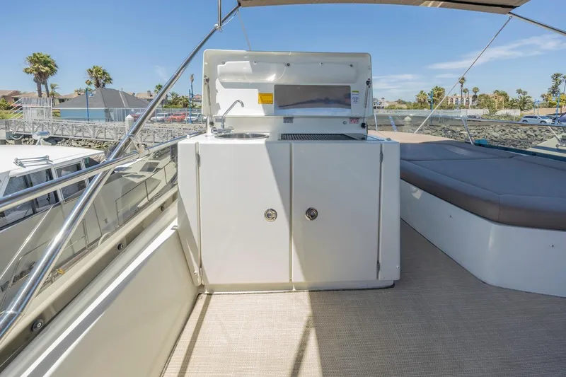 Slide: The Image of Flybridge of 2015 Prestige 500FB yacht with outdoor kitchen and seating area. - 22