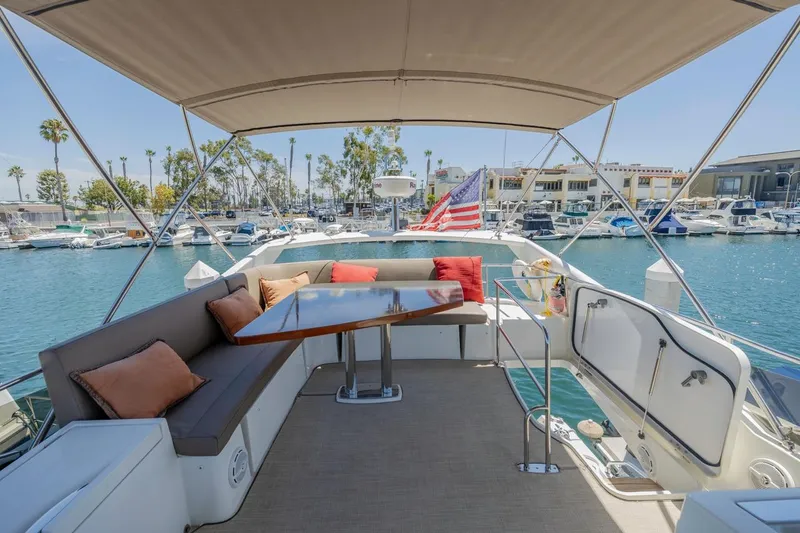 Slide: The Image of Luxurious 2015 Prestige 500FB yacht with spacious deck, seating, and marina view. - 26