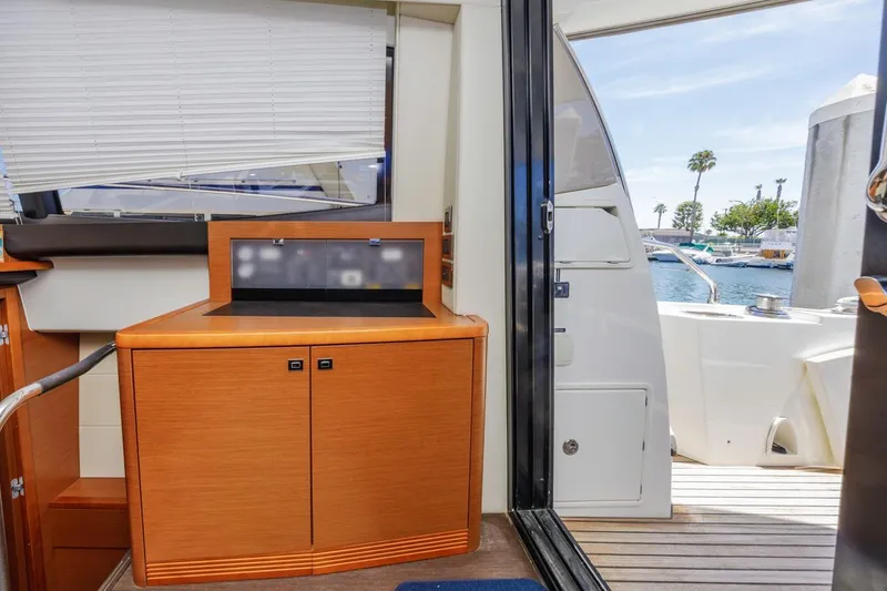 Slide: The Image of Interior view of 2015 Prestige 500FB yacht with wooden cabinetry and open deck access. - 29