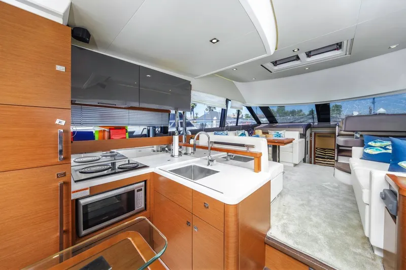 Slide: The Image of Luxurious interior of a 2015 Prestige 500FB yacht with modern kitchen and seating area. - 32