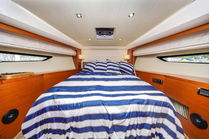 Slide: The Image of Luxurious cabin interior of 2015 Prestige 500FB yacht with striped bedding. - 38