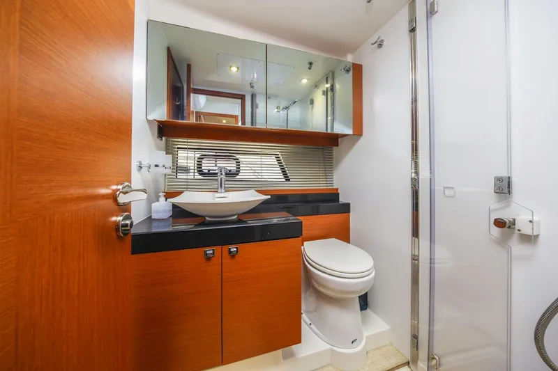 Slide: The Image of Luxurious bathroom in 2015 Prestige 500FB yacht with modern fixtures and wooden cabinetry. - 40