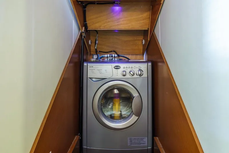 Slide: The Image of Compact laundry area with a 2015 Prestige 500FB washing machine in a wooden alcove. - 42