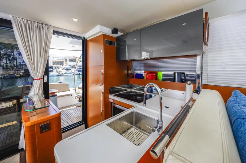 Slide: The Image of Modern kitchen interior on 2015 Prestige 500FB yacht, featuring sleek design and marina view. - 44