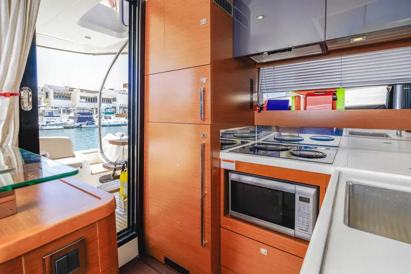 Slide: The Image of Modern kitchen interior on 2015 Prestige 500FB yacht, featuring appliances and marina view. - 45