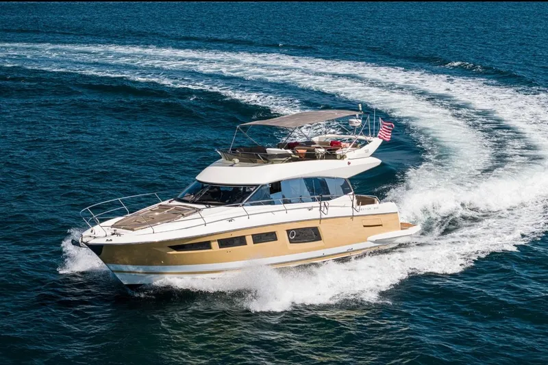 Slide: The Image of Luxurious 2015 Prestige 500FB yacht cruising on open water, showcasing sleek design and elegance. - 5
