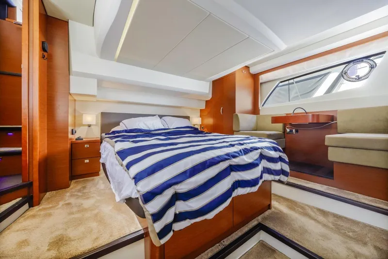 Slide: The Image of Luxurious cabin interior of 2015 Prestige 500FB yacht with cozy bed and elegant decor. - 52